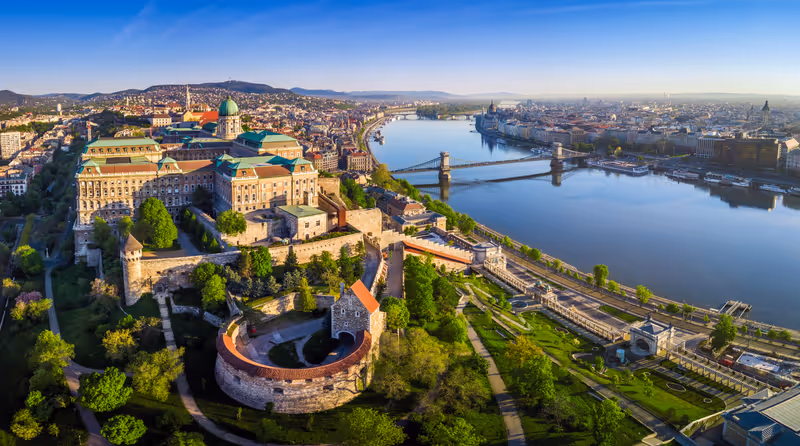 Budapest, Hungary - Aerial panoramic skyline view of Buda Castle Royal Palace with Szechenyi Chain Bridge, St.Stephen's Basilica, Hungarian Parliament and Matthias Church at sunrise with blue sky