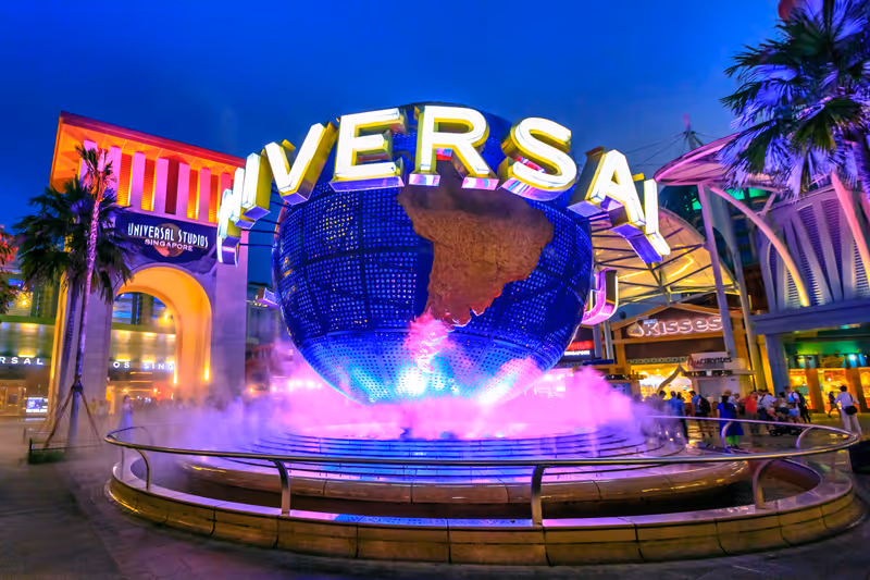 Singapore - May 2, 2018: Universal Studios with luminous globe in Sentosa island at blue hour with pink lights. Universal Studios Singapore is southeast Asia's first Hollywood movie theme park.
