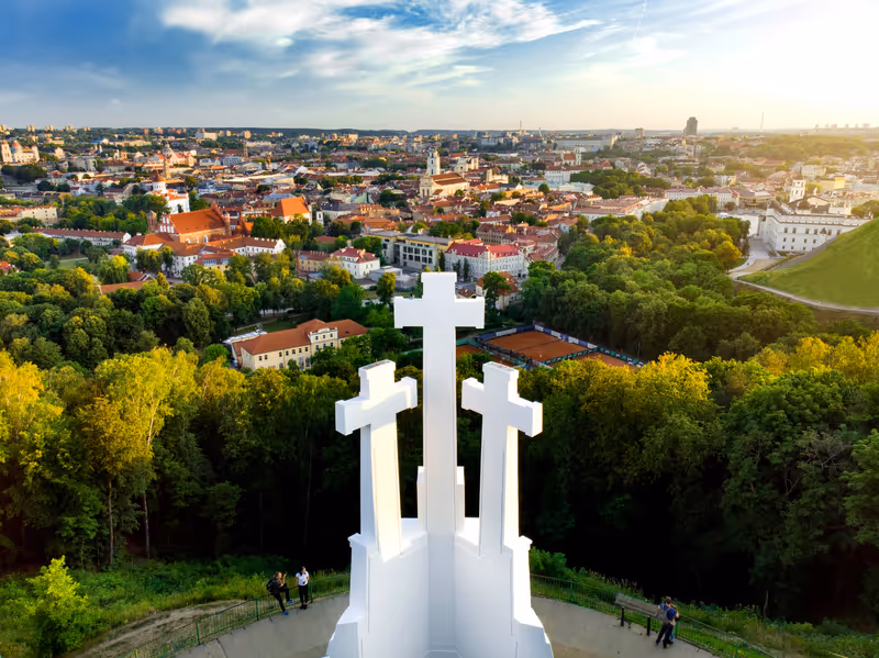 Aerial view of the Three Crosses monument overlooking Vilnius Old Town on sunset. Vilnius landscape from the Hill of Three Crosses, located in Kalnai Park, Lithuania.