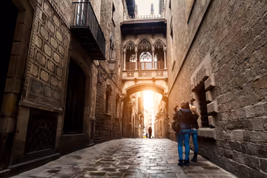 Woman tourist sightseeing in Barcelona Barri Gothic Quarter and Bridge of Sighs in Barcelona, Catalonia, Spain.