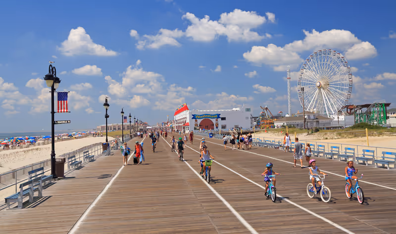 OCEAN CITY, NEW JERSEY - AUGUST 05, 2018: People walking and biking along the famous boardwalk in Ocean City, New Jersey, USA.