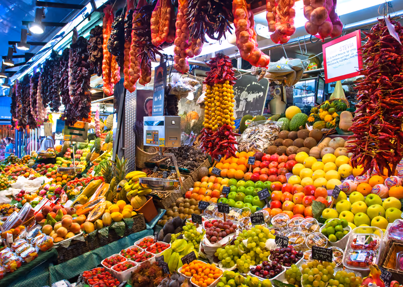 BARCELONA, SPAIN - AUGUST 31: Famous La Boqueria market with vegetables and fruits on August 31, 2012 in Barcelona, Spain. One of the oldest markets in Europe that still exist. Established 1217.
