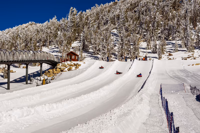 December 26, 2018 South Lake Tahoe / CA / USA - Tourists tubing on the slopes of Heavenly Ski Resort on a sunny winter day