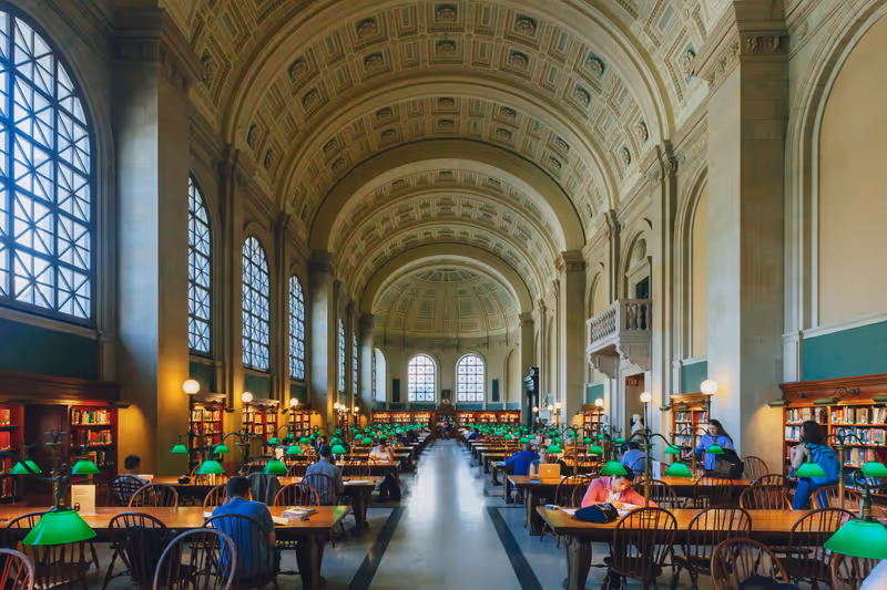 Boston, USA - May 27, 2016: Locals study and read books in the Reading Room at McKim Building of Boston Public Library