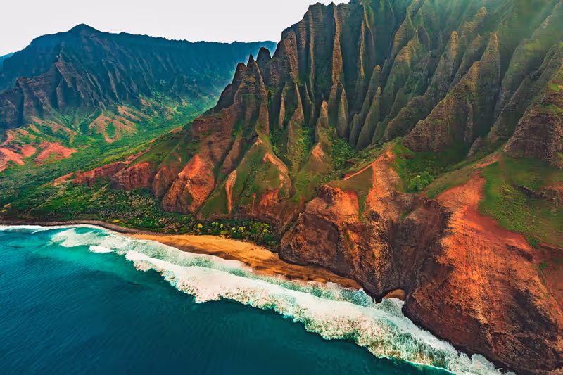 An aerial helicopter tour view of Kalalau Beach and the Kalalau Valley on the famous Na Pali Coast on the northwestern side of the island of Kauai, Hawaii, United States.