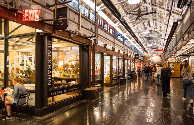 USA, New York. May 4, 2019. Chelsea market. Interior view of the entrance hall, people walking, illuminated stores