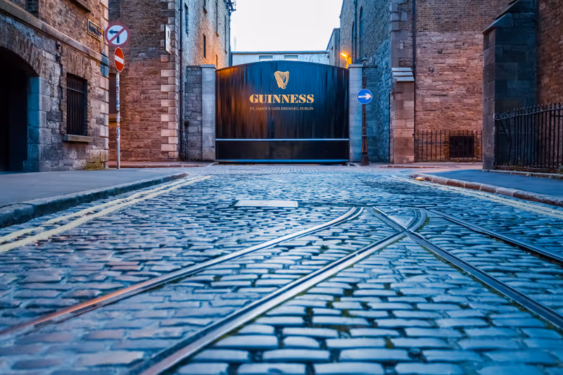 Dublin, Ireland - August 2019: Low angle shot of the closed entrance to the Guinness Brewery at St. James's Gate with an empty cobblestone street
