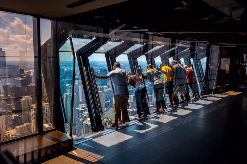 Chicago, Illinois, USA - Aug 15, 2019: Tilting glass at John Hancock Center observation area