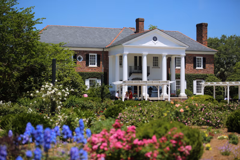Charleston, South Carolina / USA - April 15 2019: House in Boone Hall Plantation with colorful flowers in the Garden.