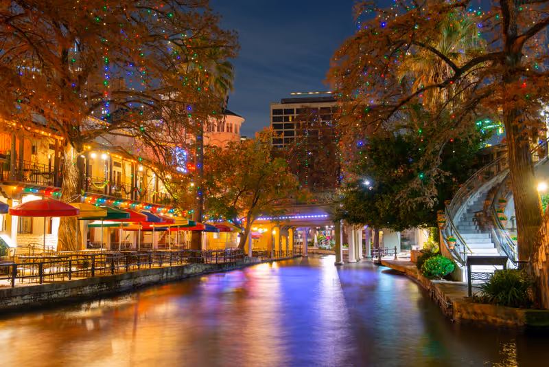 San Antonio River Walk and stone bridge over San Antonio River near Alamo in downtown San Antonio, Texas, USA.