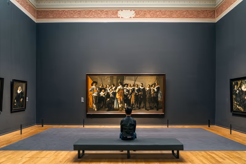 Amsterdam, Netherlands - July 20, 2019: Art lover admire the painting in Rijksmuseum