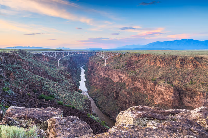 Taos, New Mexico, USA at Rio Grande Gorge Bridge over the Rio Grande at dusk.