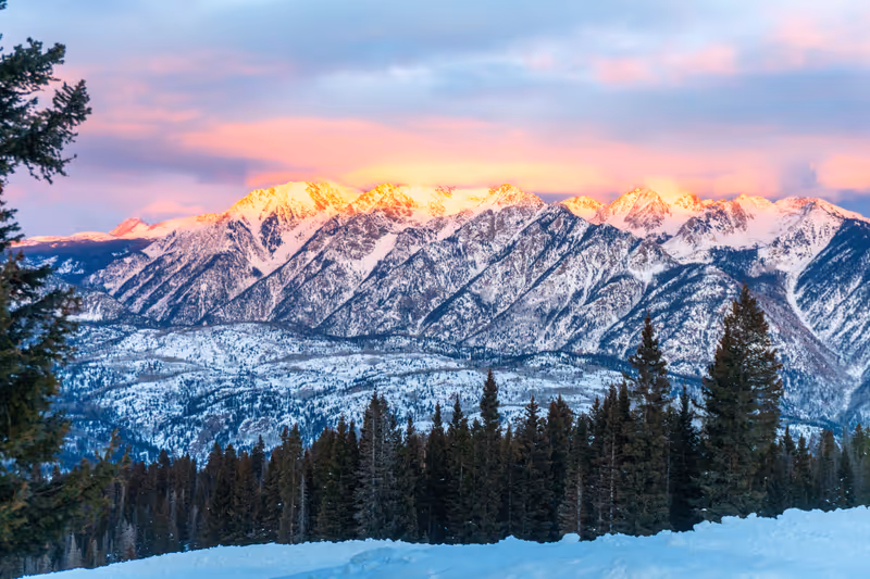 Snowshoeing tour at Purgatory Ski Resort. Alpenglow at sundown on nearby Grizzly Peak.