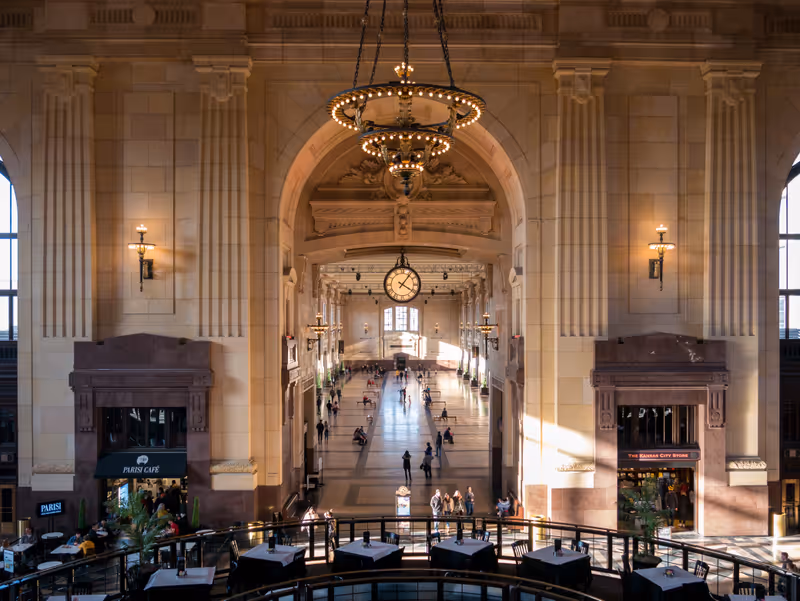 Kansas City, MO / United States of America - February 18th, 2020: View of the interior of Union Station in downtown KC from upper mezzanine, looking down main hallway, with chandeliers and warm light.