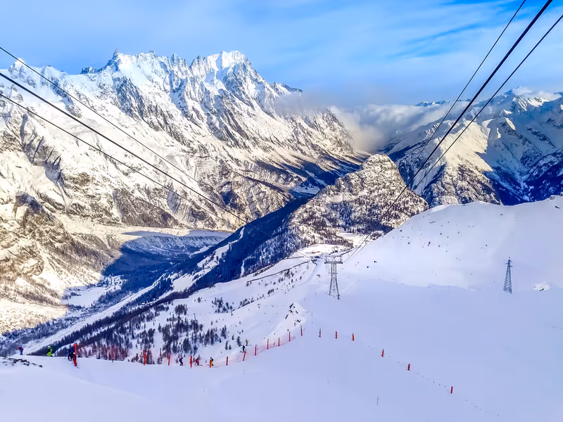 Courmayeur ski resort, Italy, Val d'Aosta aerial panorama with slope and Alps mountain peaks