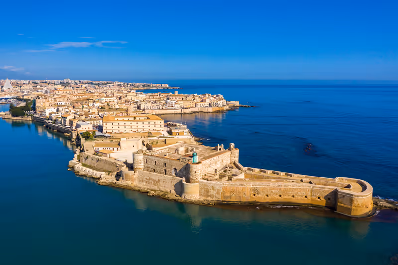 Siracusa, Ortigia Island from the air, Sicily, Italy. Isola di Ortigia, coast of Ortigia island at city of Syracuse, Sicily, Italy. Coastline town Syracuse, Sicily and old Ortigia island. Aerial view.