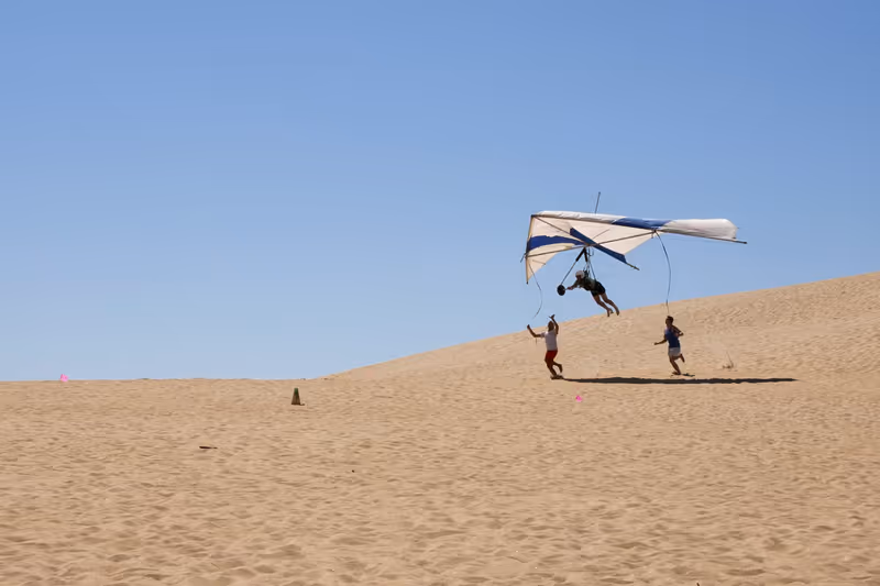 Kitty Hawk, NC, USA - September 25, 2012 : Students learning to fly at the Hang Gliding School located in the sand dunes of Jockey's RIdge State Park, Kitty Hawk,North Carolina