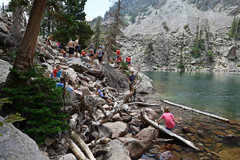 Rocky Mountain National Park, Colorado - July 26, 2021 - Visitors hike on crowded Emerald Lake Trail on sunny summer morning.