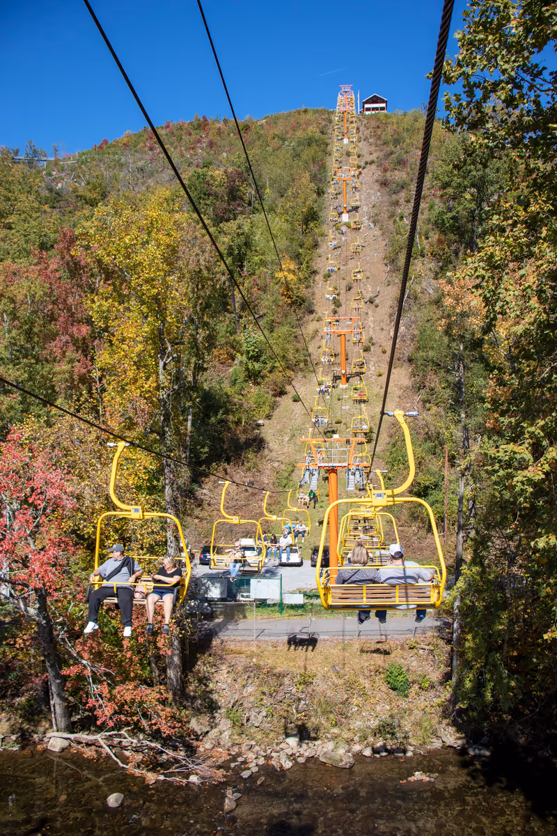 Gatlinburg, Tennessee - OCT 21 2020: Skylift carrying people up a mountain side on a sunny fall day
