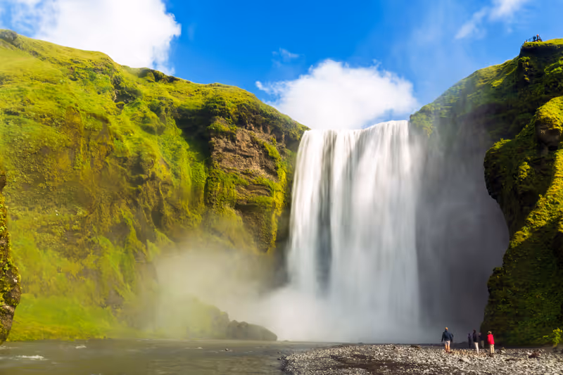 Rainbow over Skógafoss, a waterfall on the Skógá River in the south of Iceland at the cliff marking the former coastline