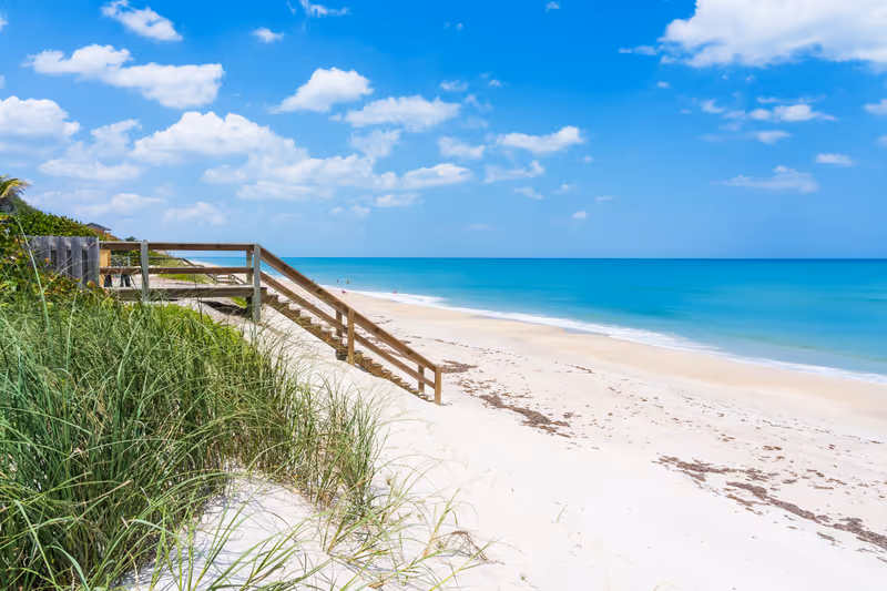Wooden stairs to the beach by the ocean from a private home in Florida, Melbourne Beach. Typical beach view in Florida
