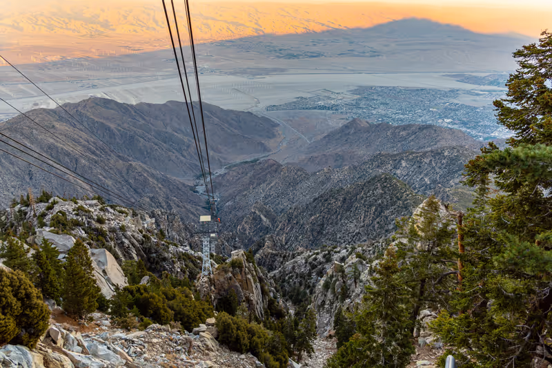 Cable car leading up to Mount San Jacinto in Palm Springs during sunset with pastel background.