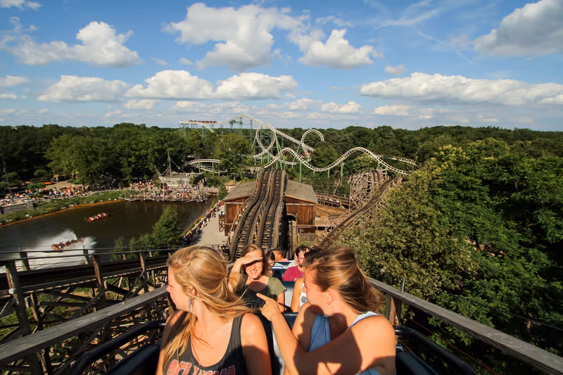 Kaatsheuvel, The Netherlands - June 22, 2014 : Blonde Dutch girls in a train of the wooden roller-coaster "Joris en de Draak" in Efteling, a theme park in the Netherlands, in the lift-hill