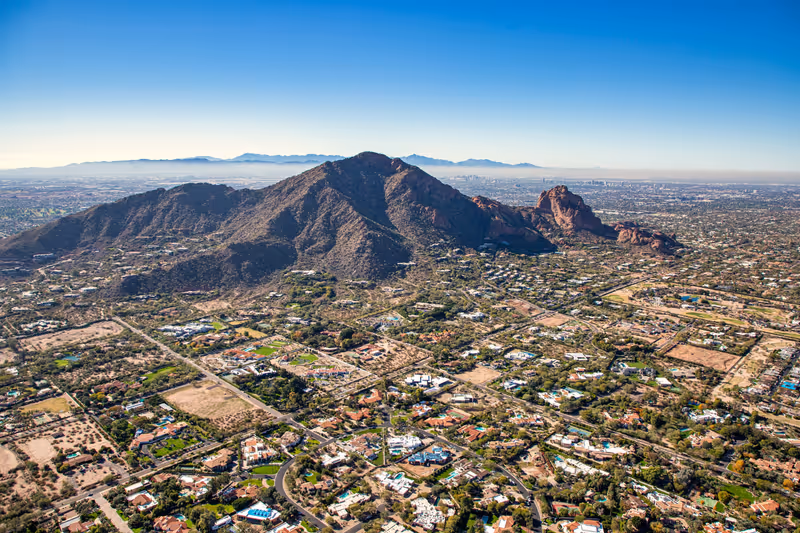Aerial view above Paradise Valley, Arizona looking SW at Camelback Mountain on a cool December morning 2022