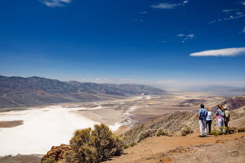 DEATH VALLEY, CALIFORNIA, USA - APRIL 2016: Group of tourists admiring beautiful view of Death Valley from Dante's View viewpoint, California, USA. Exploring the American Southwest.