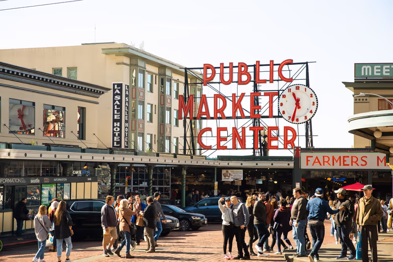 Seattle, Washington, United States - October 6, 2019: Crowds of tourists gather outside the Pike Place Public Market on a clear, afternoon fall day.