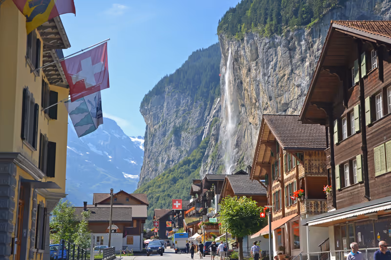 Lauterbrunnen - August 22, 2013: view of Lauterbrunnen town with the Staubbach Falls. The town is a popular tourist attraction and gateway to the Jungfrau.