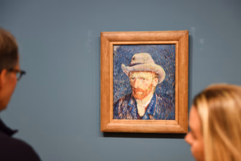 Amsterdam, Netherlands. March 2023. Visitors looking at a self portrait of the famous painter Van Gogh. High quality photo