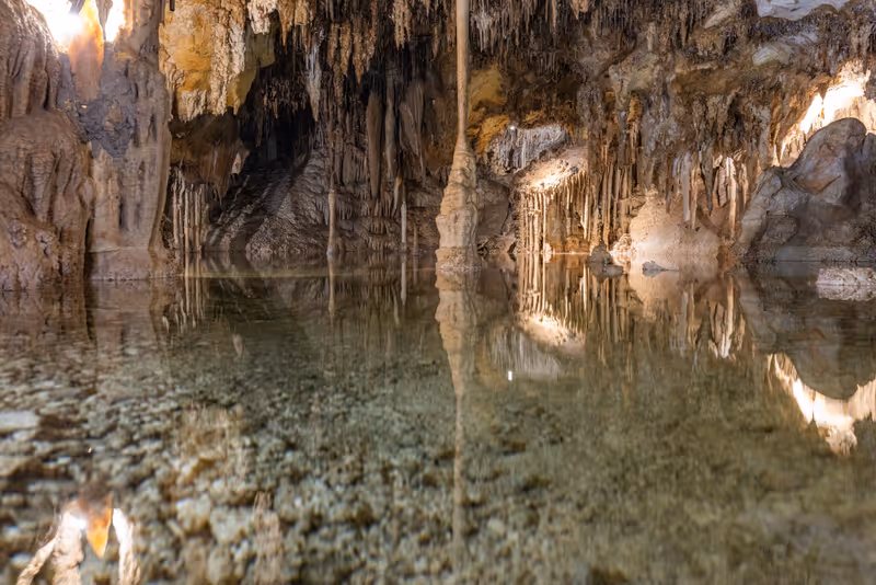 Underground pool with calm reflections with stalactites hanging from the ceiling inside the Lehman Caves in Great Basin National Park