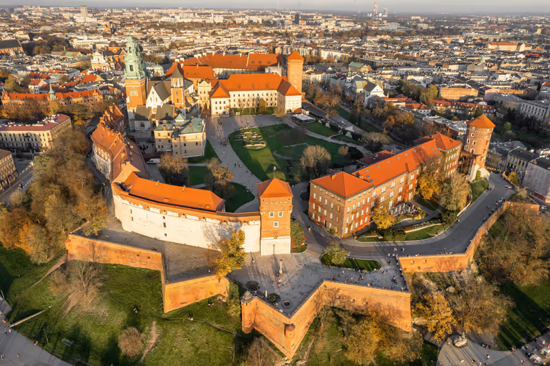 Historic royal Wawel castle in Cracow at sunrise, Poland. Aerial view of the Krakow skyline with Wawel Hill, Cathedral, Royal Wawel Castle, defensive walls. Krakow old town from above
