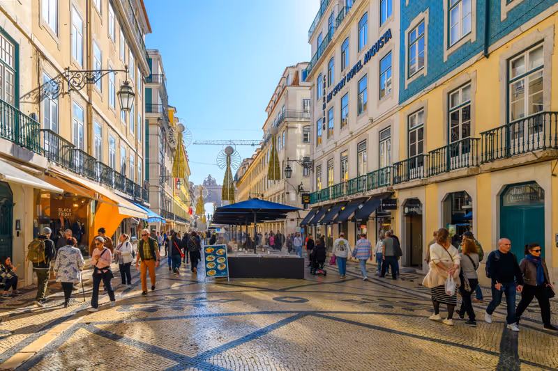 Lisbon, Portugal - January 3 2024: The popular Rua Augusta street, full of shoppers and diners enjoying the stores, restaurants and sidewalk cafes and calçada pavement in the Bairro Alto district