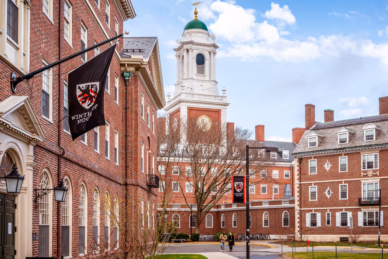 Cambridge, MA, USA - March 15, 2024: View of the architecture of the famous Harvard University in Cambridge, Massachusetts, USA showcasing it brick buildings with some students and locals passing by .