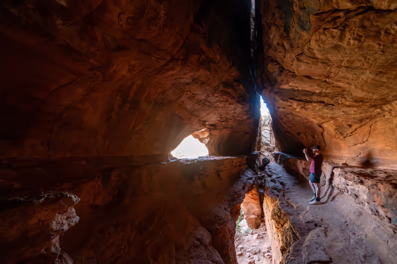 Sedona, Arizona - March 10, 2024: Man takes a photo up inside the Solider Pass Cave in Sedona Arizona