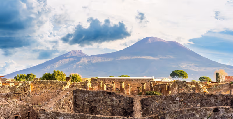 beautiful landscape from Pompeii ancient archeological excavation to Vesuvius volcano and amazing cloudy cky on background