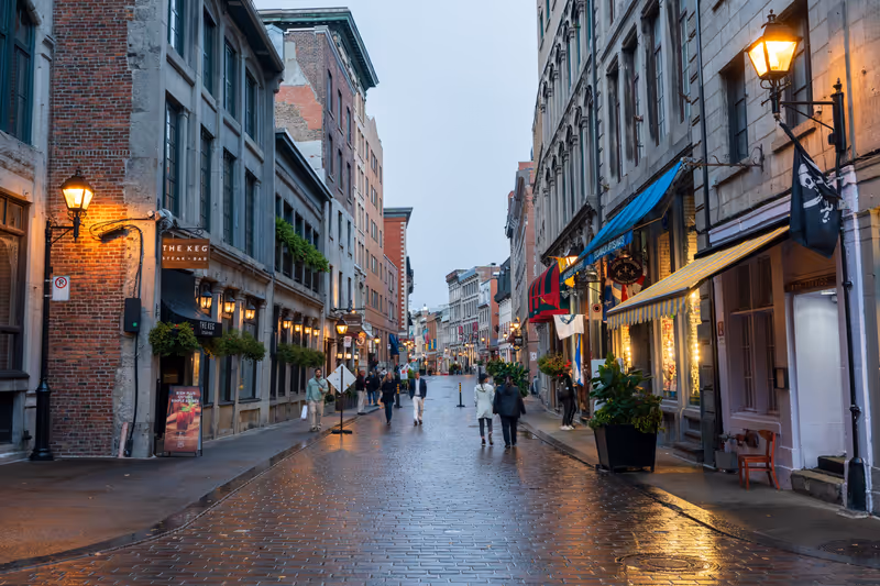 Montreal, Quebec, Canada - October 19 2022 : Street view of Old Montreal on a rainy evening. Saint Paul East Street (Rue Saint-Paul East).