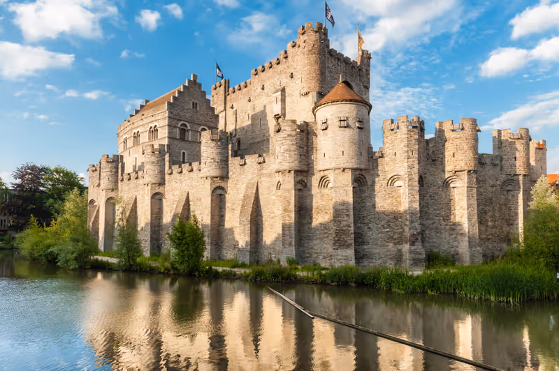 Castle Gravensteen, Ghent. Medieval castle Gravensteen (Castle of the Counts) in Ghent, Flanders, Belgium. Legendary castle with small windows surrounded by water in moat in Ghent, Flanders, Belgium.