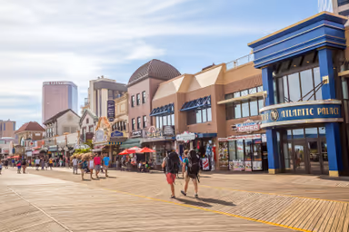 ATLANTIC CITY,  NEW JERSEY - August 3: The boardwalk and Casinos on August 3, 2015 in Atlantic City, New Jersey. Gambling was legalized in the city in 1976 and led to a resurgence.