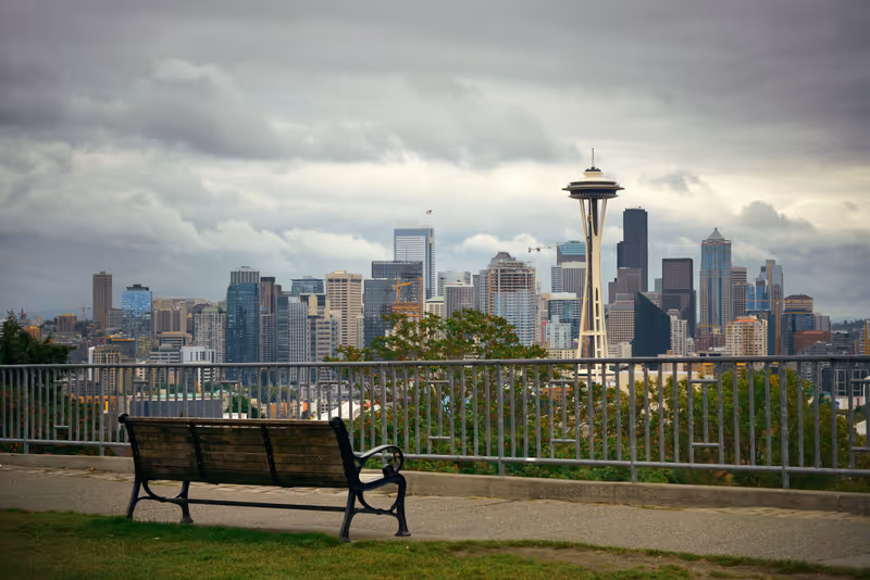 Seattle city view from Kerry Park with urban architecture and bench.