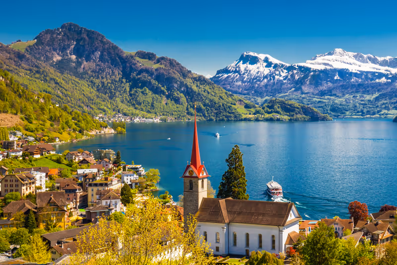 Famous boats on lake Lucerne (Vierwaldstatersee) in Weggis village with the view of Pilatus mountain and Swiss Alps in the background near famous Lucerne (Luzern) city, Switzerland
