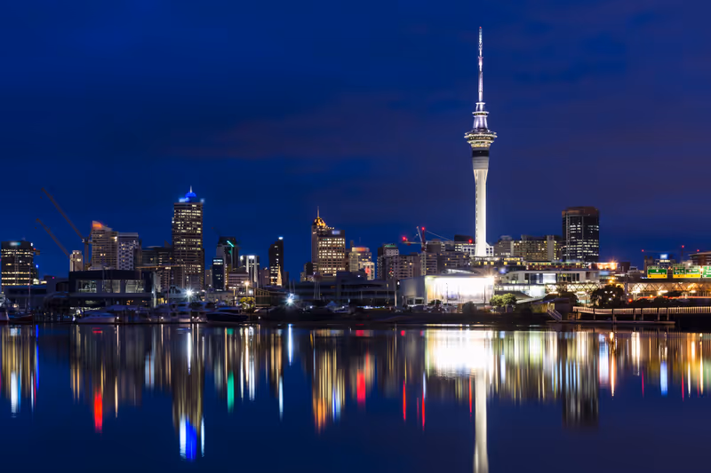 A beautifully still winter's morning in Auckland. The city is waking and Sky Tower is illuminated.